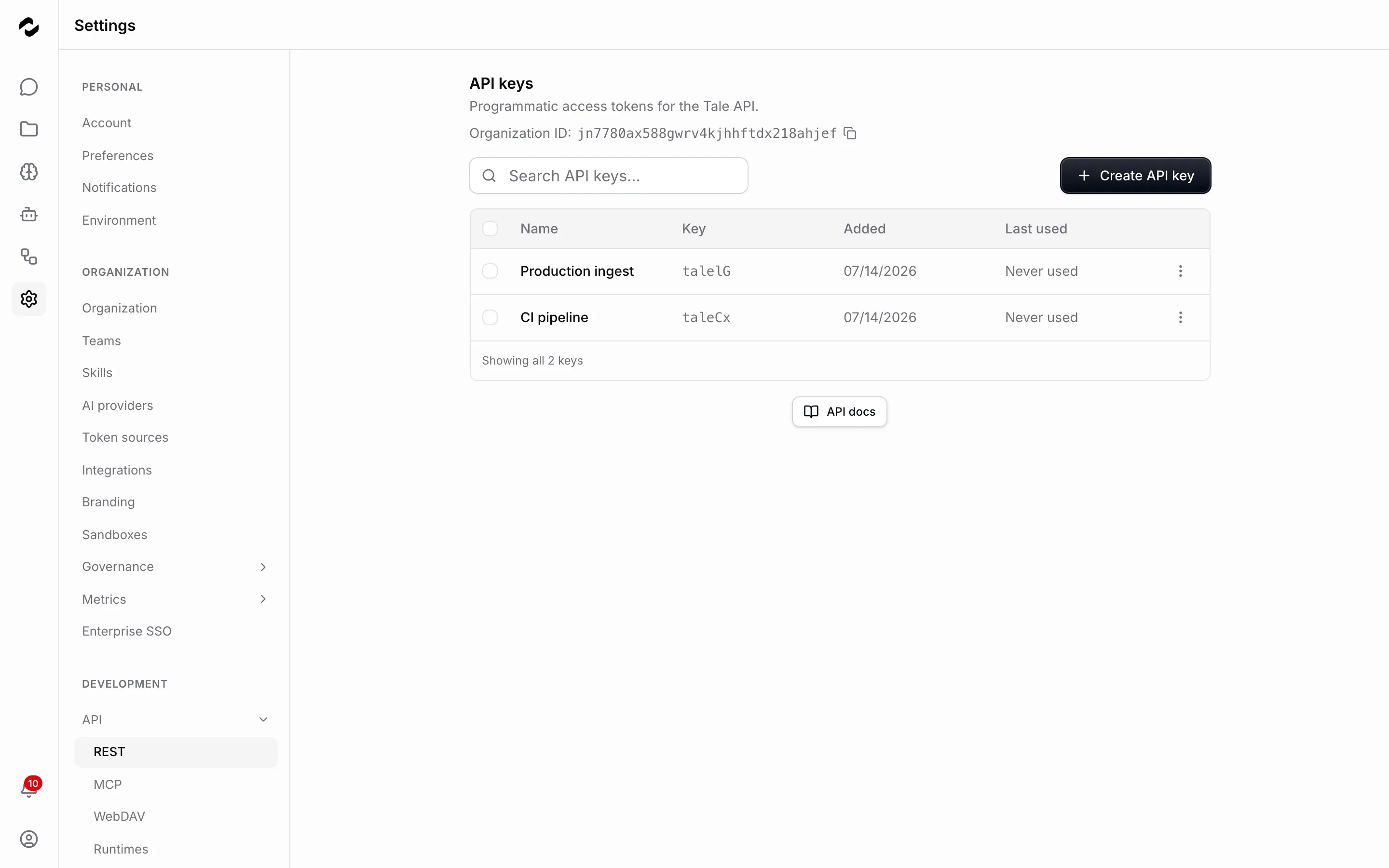 The REST API keys settings page listing two keys — Production ingest and CI pipeline — each showing only its key prefix, the date it was added, and a Never used marker, beside a Create API key button.