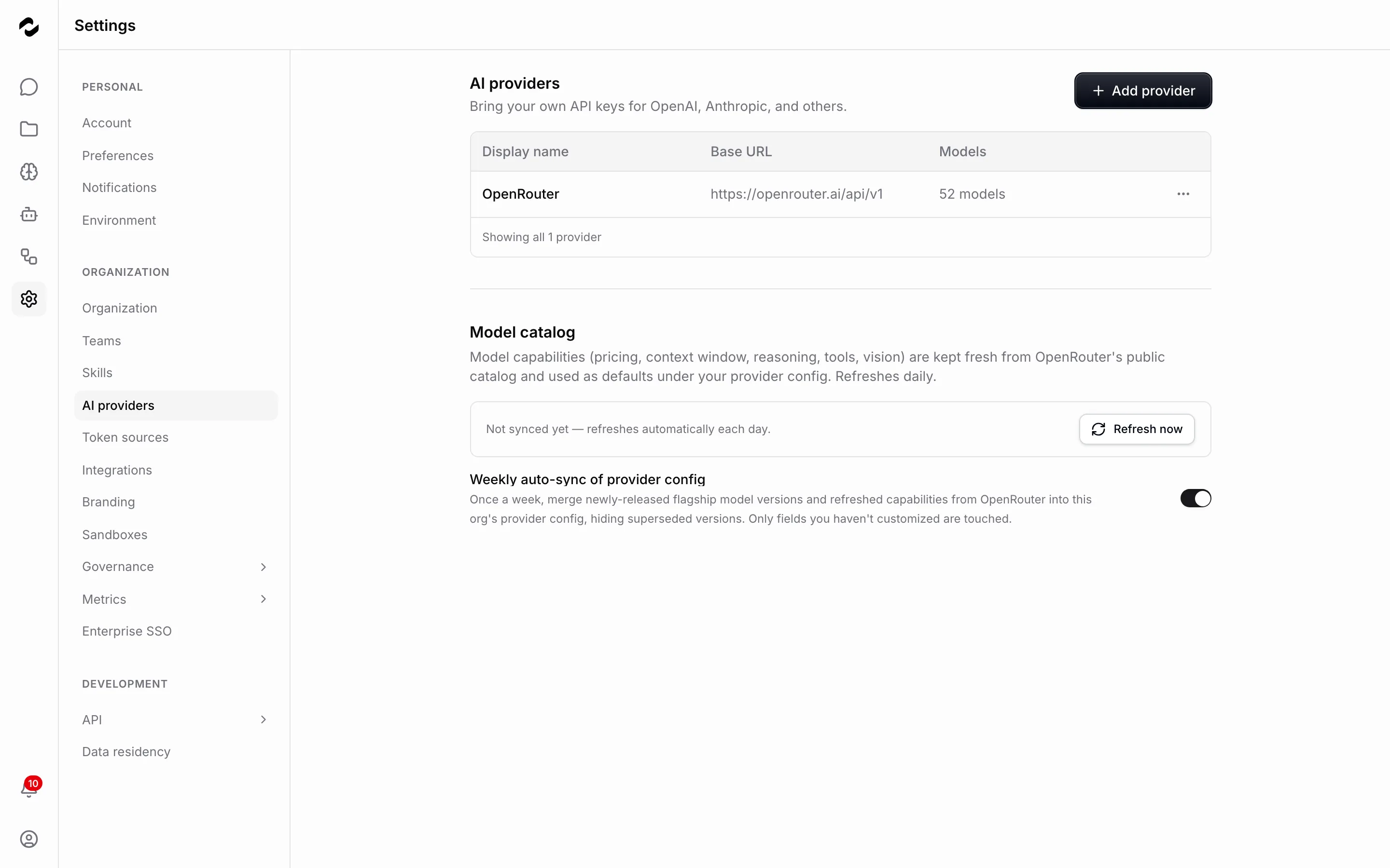 The AI providers settings page listing one connected provider, OpenRouter, with its base URL and a count of 52 models.