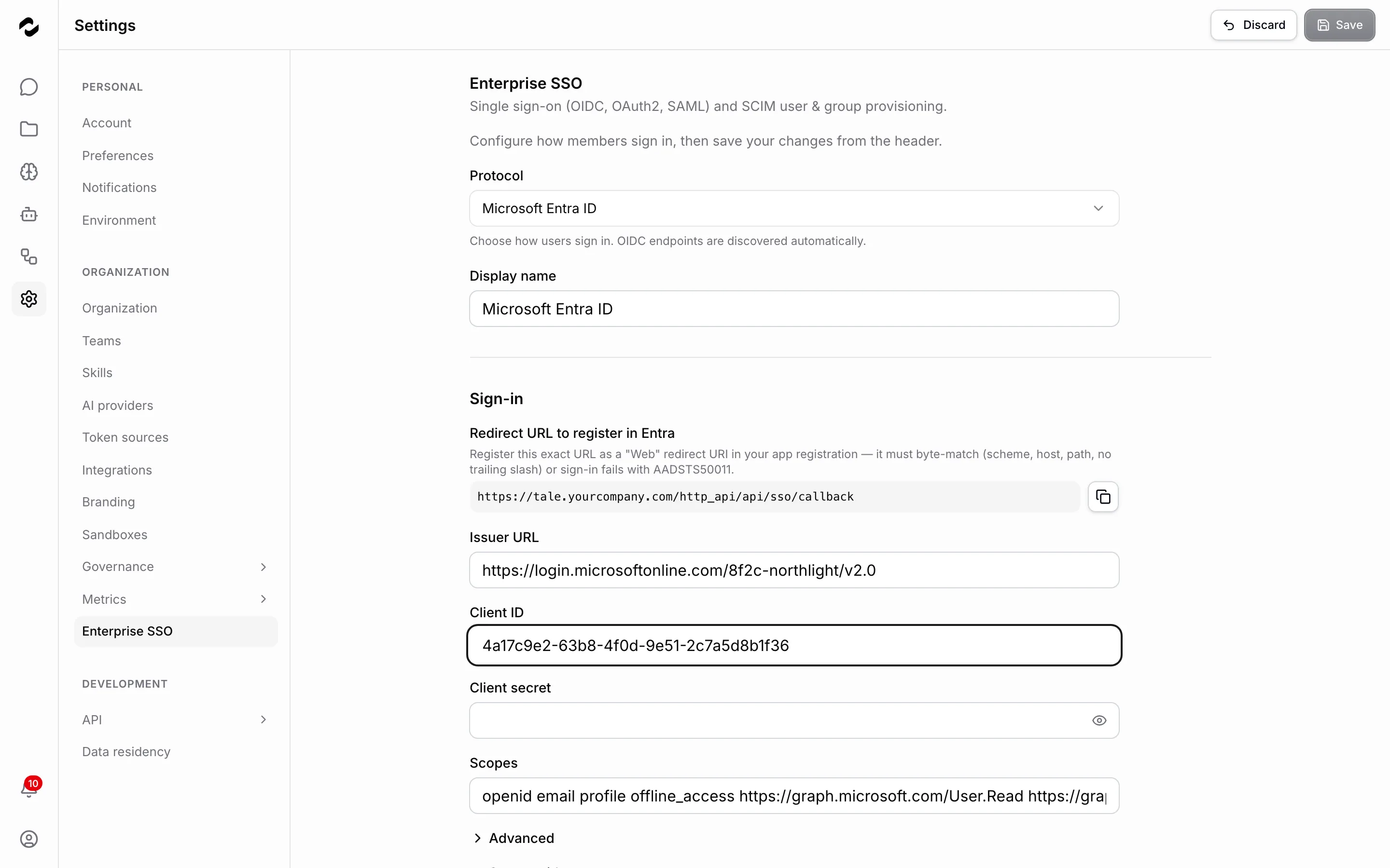 The Enterprise SSO settings page with the Protocol dropdown set to Microsoft Entra ID and a matching display name, and a sign-in section carrying the redirect URL to register, an issuer URL and client ID filled in from the app registration, an empty client secret, and the requested scopes.
